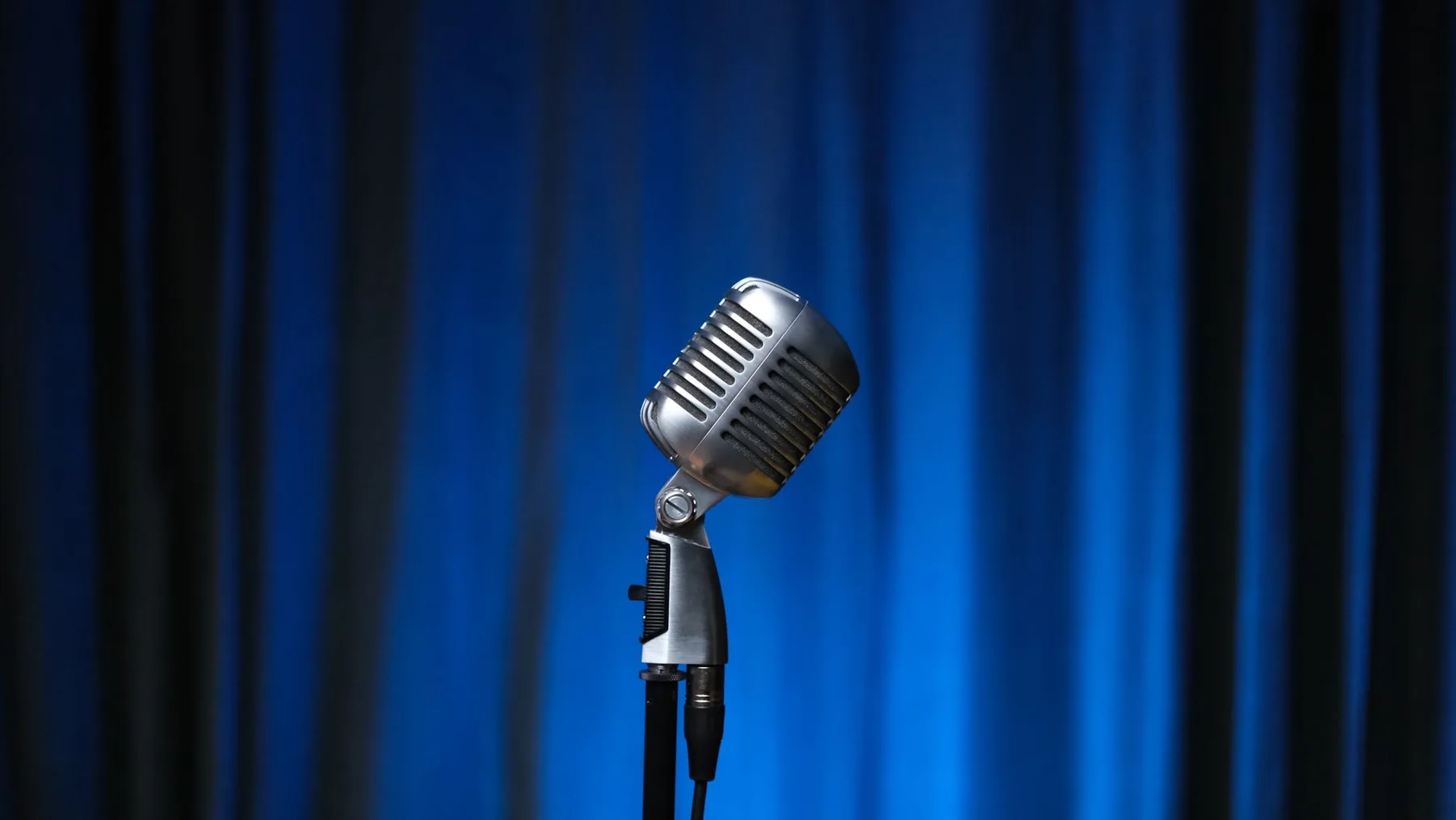 vintage microphone on a blue stage vintage microphone on a blue stage