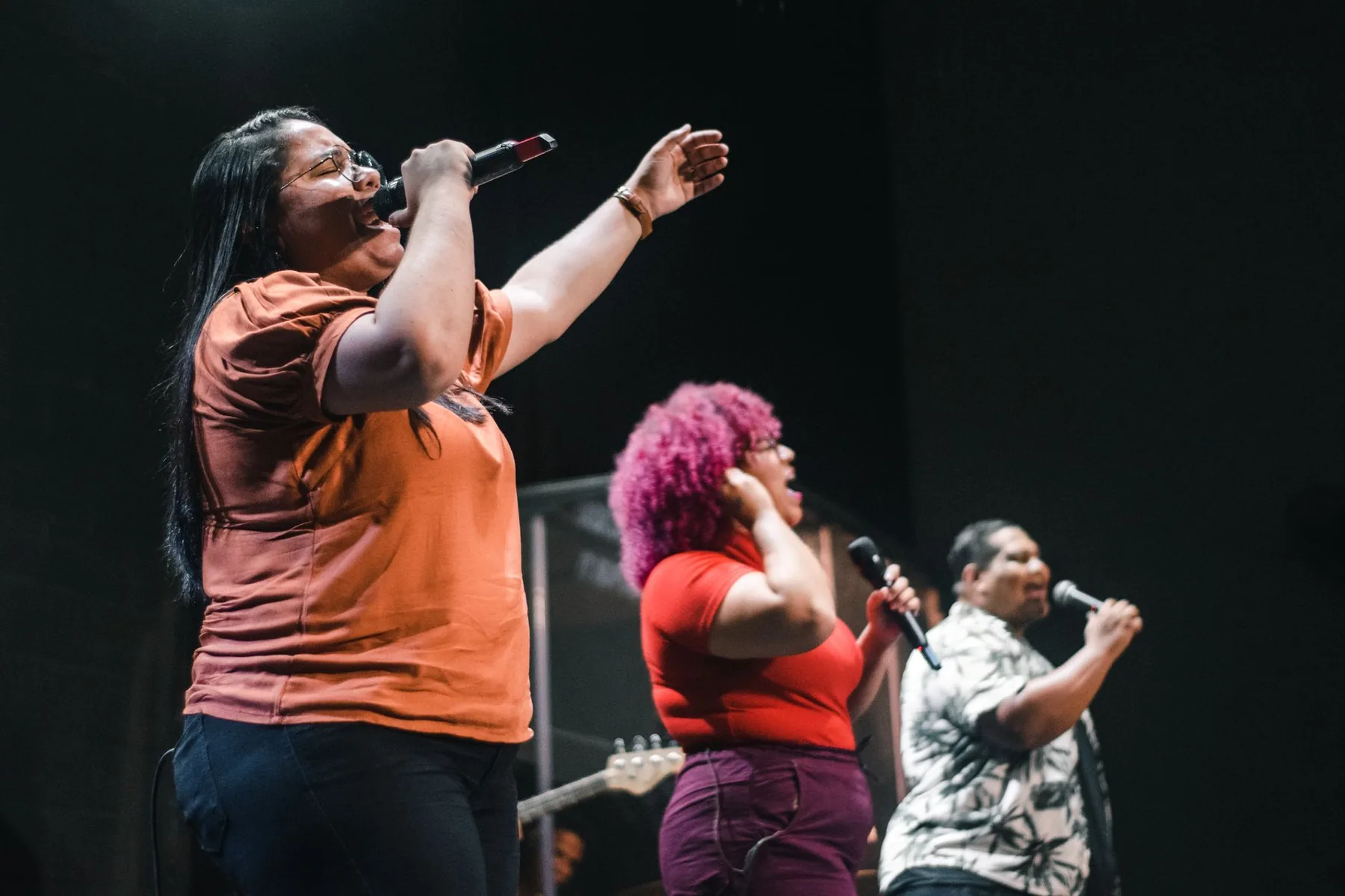 group of singers with microphones on a karaoke stage group of singers with microphones on a karaoke stage