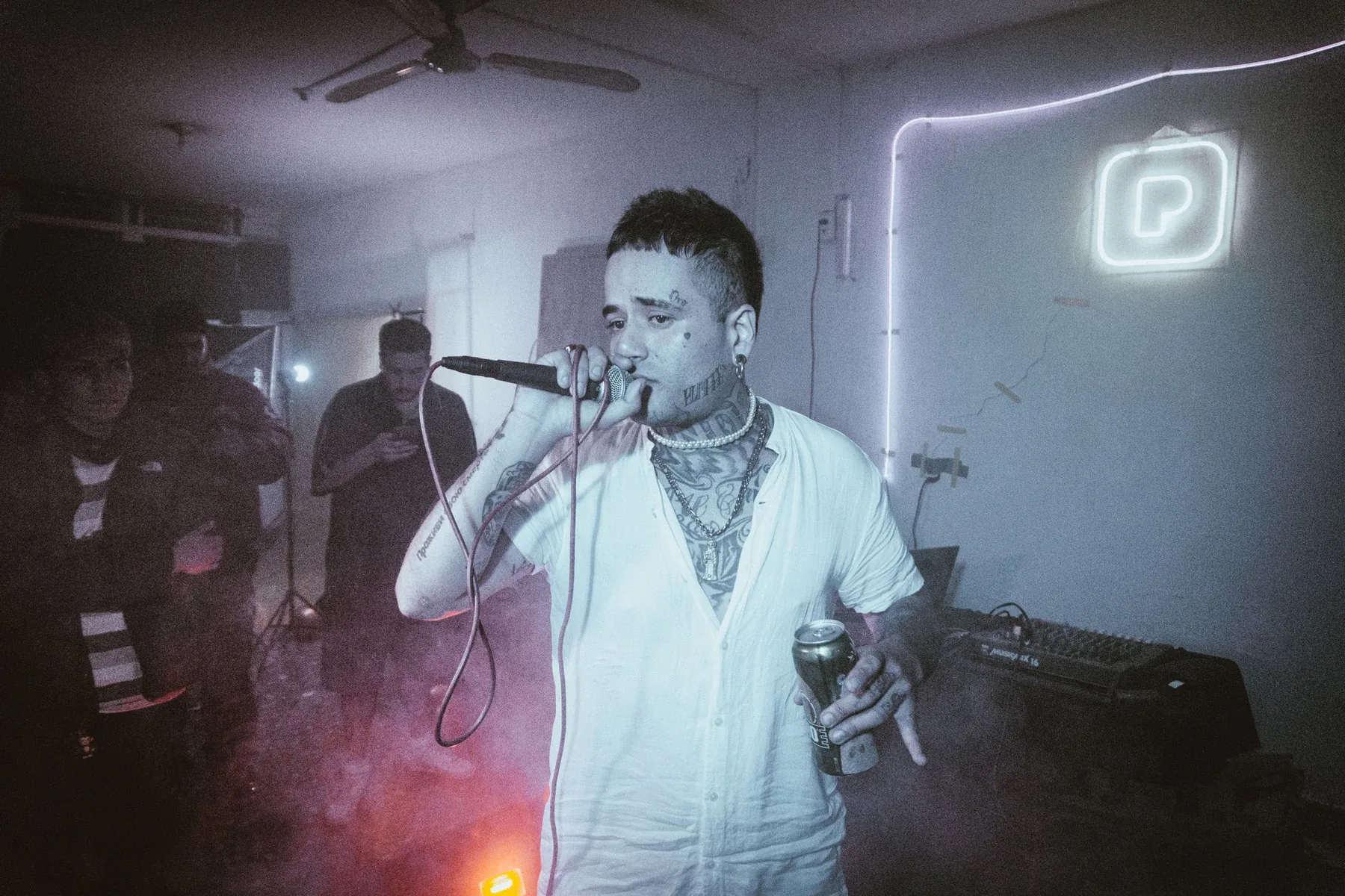 singer at a microphone in front of an audience singer at a microphone in front of an audience