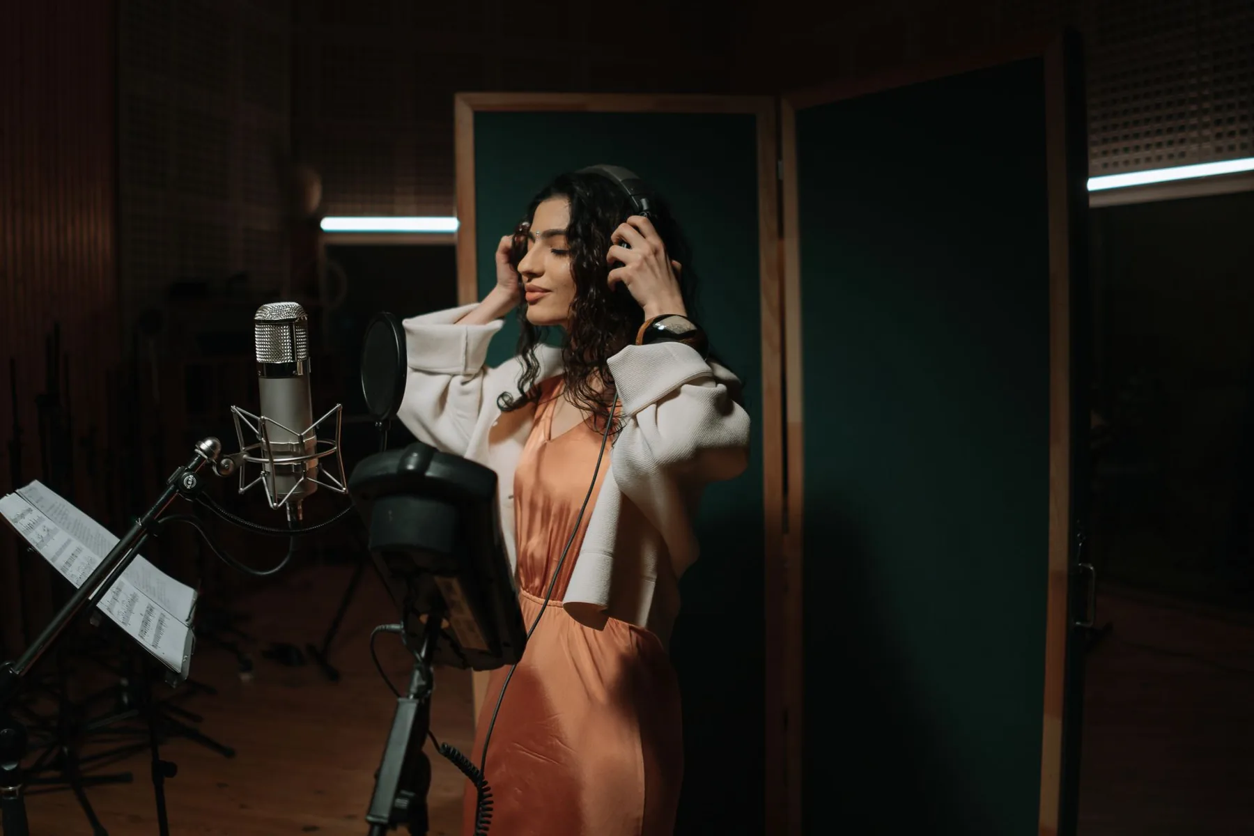 singer in a studio with a microphone and headphones singer in a studio with a microphone and headphones