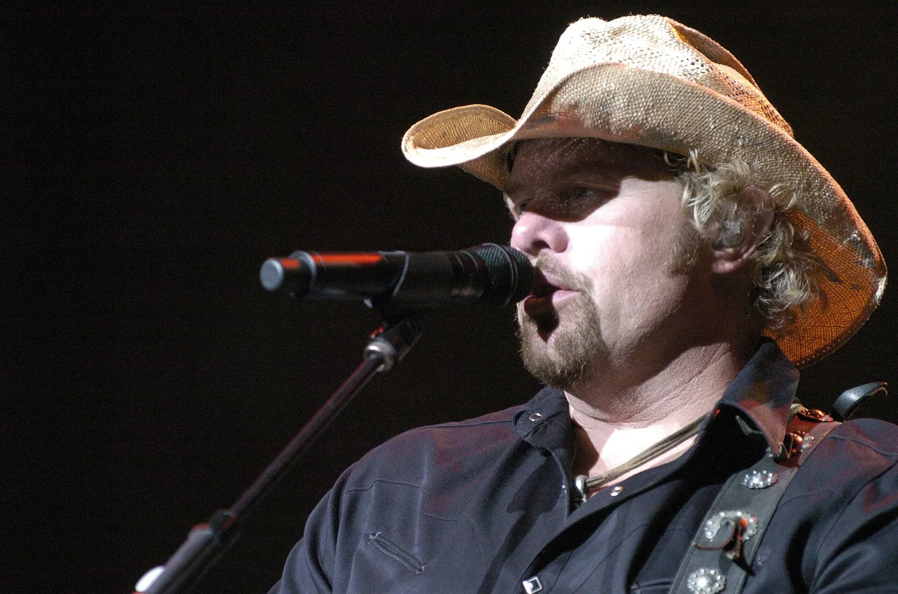 country singer at a stage microphone country singer at a stage microphone
